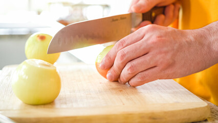 Young Man Enthusiastically Preparing Dinner in Modern Kitchen