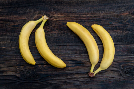 Banana on a wooden table. ripe yellow bunch of bananas on the kitchen table. view from above