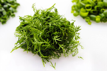 Chopped dill lies on a white background. Organic dill grown on the farm. Organic farming concept. Cooking concept