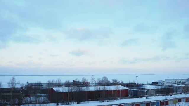 Lake Onega, Petrozavodsk, Karelia. Industrial landscape. Frosty winter. Blue sky clouds. Slow motion. Real time. View of the ice-frozen lake from Klyuchevaya. Ivanovo Islands, Baraniy Bereg Peninsula