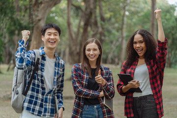 Obraz premium Happy group of college students use laptop feel excited overjoyed with good news over smartphone or Tablet.