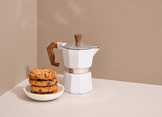 Geyser coffee maker and chocolate chip cookie. Light breakfast. Copy space for text.