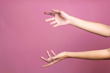Woman hands holding or giving something big like bag or gift box over pink background