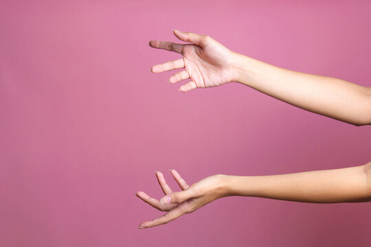 Woman Hands Holding Or Giving Something Big Like Bag Or Gift Box Over Pink Background