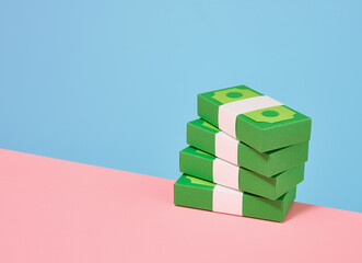 Naklejka premium Some green paper stacks of money. Copy space for text.