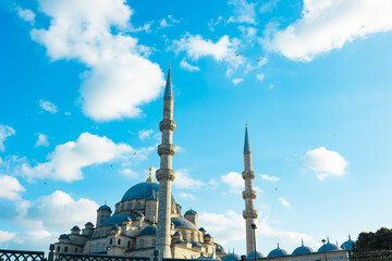 Fototapeta na wymiar Eminonu Yeni Cami or New Mosque view at sunset with partly cloudy sky