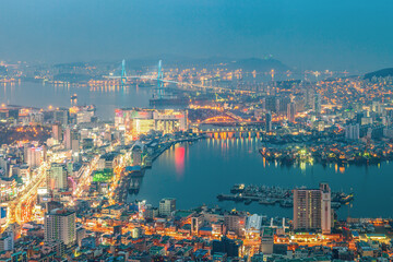 The night view of the city. The night view of Busan Port with colorful building, road, and bridge from the observation deck of Cheonmasan Mountain in Busan, Korea.