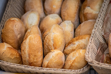 Close-up image of freshly baked bread rolls displayed in wicker baskets at a bakery or market in Altamura, Bari, Puglia, Italy