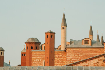 Fototapeta na wymiar Topkapi Palace. The roof and red brick chimneys of Harem. Istanbul, Turkey