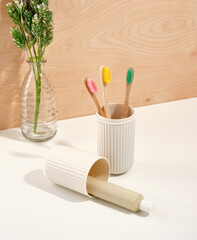 Ecological toothbrushes with colorful bristles. Eco friendly toothpaste. Oral care accessories.