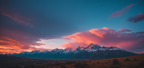 Fototapeta na wymiar Mountain landscape with orange-teal pinkish clouds 