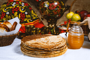 Pancakes with honey on the table in the Ukrainian  or Russian style