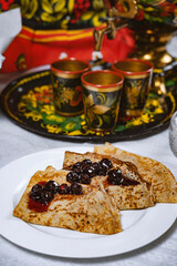 Pancakes with black currant jam on a plate, Ukrainian  or Russian style