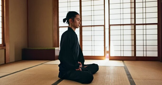 Martial arts man, meditation and exercise in Japanese dojo with mindfulness, zen or chakra balance in morning. Fighter, sport or karate person for peace, breathing or calm for yoga, wellness or floor