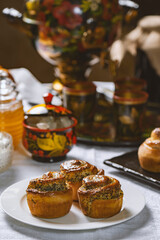 Obraz na płótnie Canvas Baked buns with poppy seeds on a white tablecloth. Ukrainian or Russian style