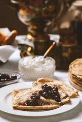 Pancakes with black currant jam on a plate, Ukrainian  or Russian style