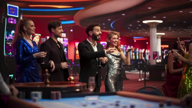 Group of Young Friends Walking in Modern Casino, Having Fun on the Night Out. Glamorous Smartly Dressed People Enjoying Luxury Lifestyle in a Gorgeous Venue, Feeling Lucky to Bet and Win. Slow Motion