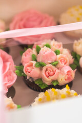 Delicious Gourmet Cupcakes Topped with Buttercream Frosting Flowers