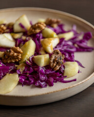 Fototapeta na wymiar Winter Salad with Red Cabbage, Apple, and Walnuts - Healthy Eating for Weight Loss