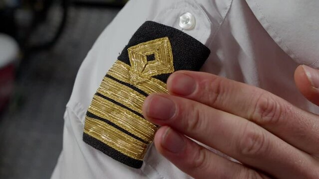 Captain four striped shoulder epaulettes, close up
