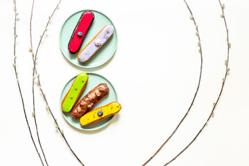 Sweet food on plates - many icing eclairs cakes