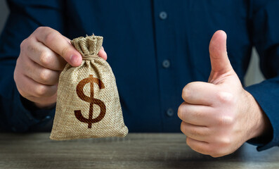 The man approves the deal or loan. Thumbs up and dollar money bag. Agreement to be hired for a job...