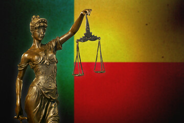 Lady Justice against a flag of Benin