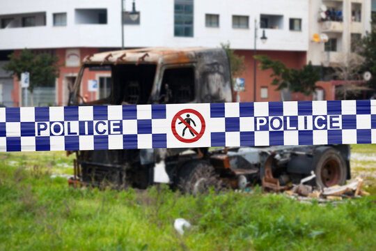 Australian police tape barricading a burnt truck