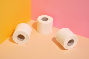 Three rolls of white toilet paper. Hygiene and order.