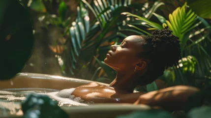 Crédence de cuisine en verre imprimé Spa African american woman relaxing in the bath on a background with tropical plants. spa treatment, concept of body and skin care.