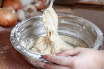 Spoon with dough over bowl....