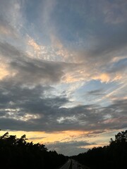 highway in the countryside, dramatic clouds at the sunset sky