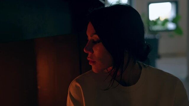 Girl looking at the fire in the fireplace