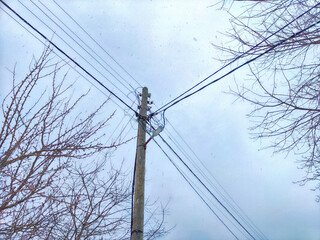 Old pole with wires against the sky. Electric transmission line. Eco-friendly energy