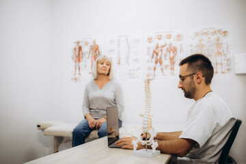 Senior lady in the doctor's office, she has back pain and rheumatism symptoms