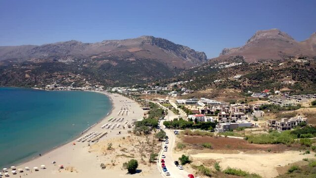 Aerial footage of Plakias beach on a sunny day in Plakias village, Rethymno, Crete island, Greece