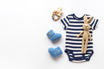 Flat lay of blue baby clothing and accessories. Kids bodysuit and shoes flat lay