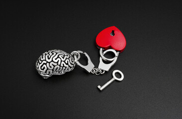 Unlocking Passion: Human Brain Model, Heart Padlock, and Key on Black Background