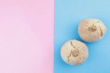 Typical Sardinian soft almond biscuits, on the table pink and light blue colors, copy space for text.