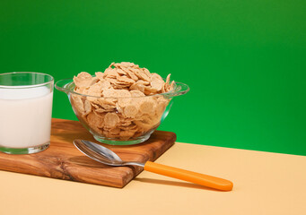 Useful and tasty breakfast. Cereal, fresh milk and kitchen utensils. Copy space for text.