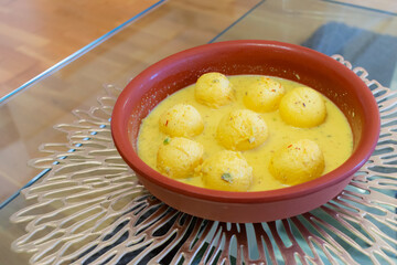 Traditional Indian dessert. Ras malai balls with sauce in a clay plate. Homemade sweet. Hindu festival. Diwali.