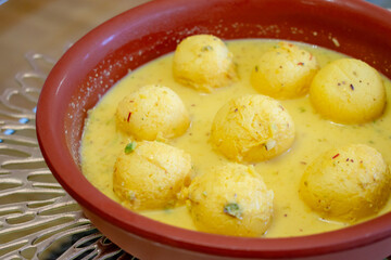 Traditional Indian dessert. Ras malai balls with sauce in a clay plate. Homemade sweet. Hindu festival. Diwali.