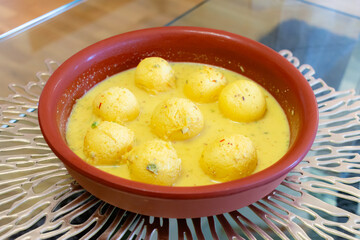 Traditional Indian dessert. Ras malai balls with sauce in a clay plate. Homemade sweet. Hindu festival. Diwali.
