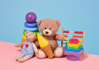 Colorful collection of kids toys and childhood. Soft bears, sand toys, abacus, ice cream and pyramid with colored rings.