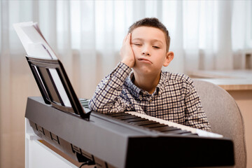 Boring Piano Lessons. Sad Tired Boy Child Hates Playing the Piano. Difficult Learning to Play...