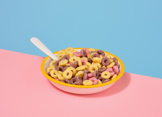 A breakfast cereal in the form of colored rings. Healthy diet and body shaping.