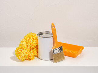 Set of various construction tools. Roller tray, paint brush and can. Nice yellow flowers.