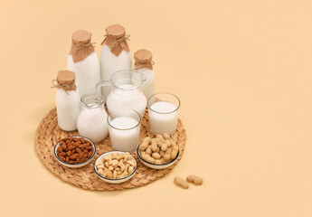 Bottles with fresh and white milk, various nuts. Copy space for text.