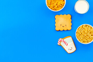 Kids breakfast with milk and funny cookies with cornflakes