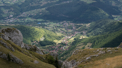 Sunspot on settlement in valley, view from mountain Vlasic